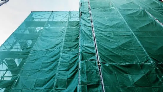 Debris netting wrapped around a building